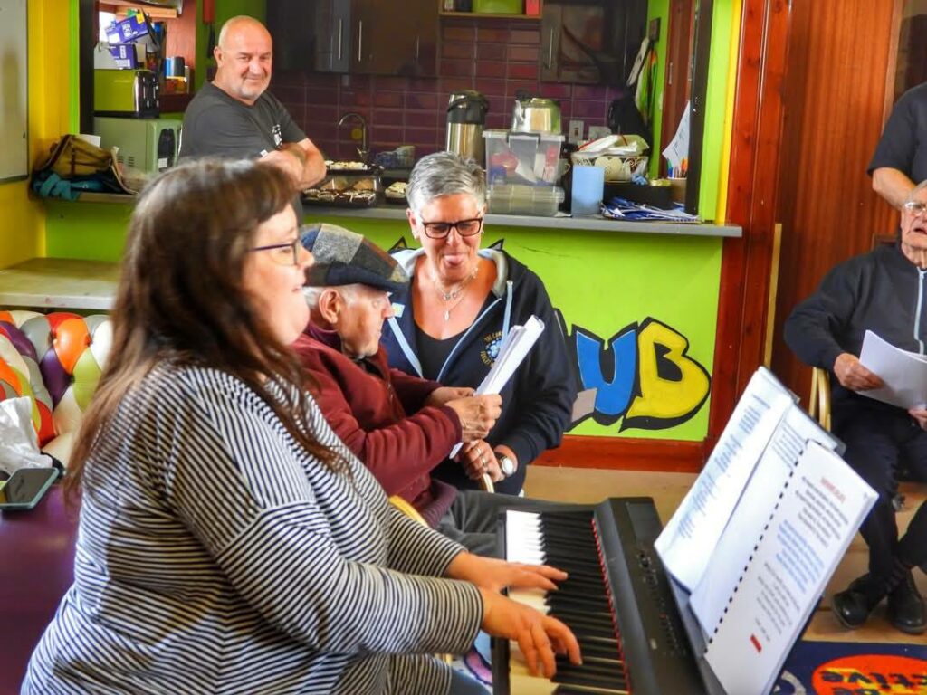 The choir singing along to the keyboard player