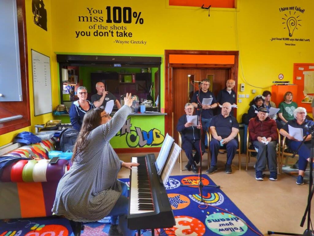 The choir singing along to the keyboard player